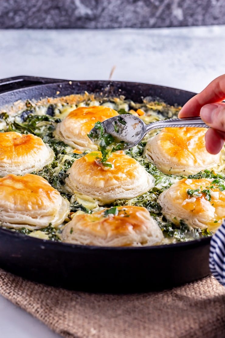 Side on shot of garlic butter being drizzled over skillet vegetable pie