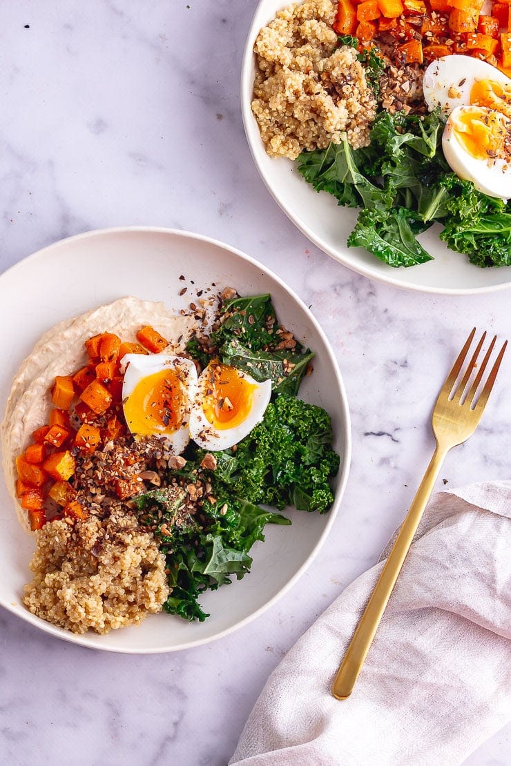 Overhead shot of two breakfast bowls on a marble surface