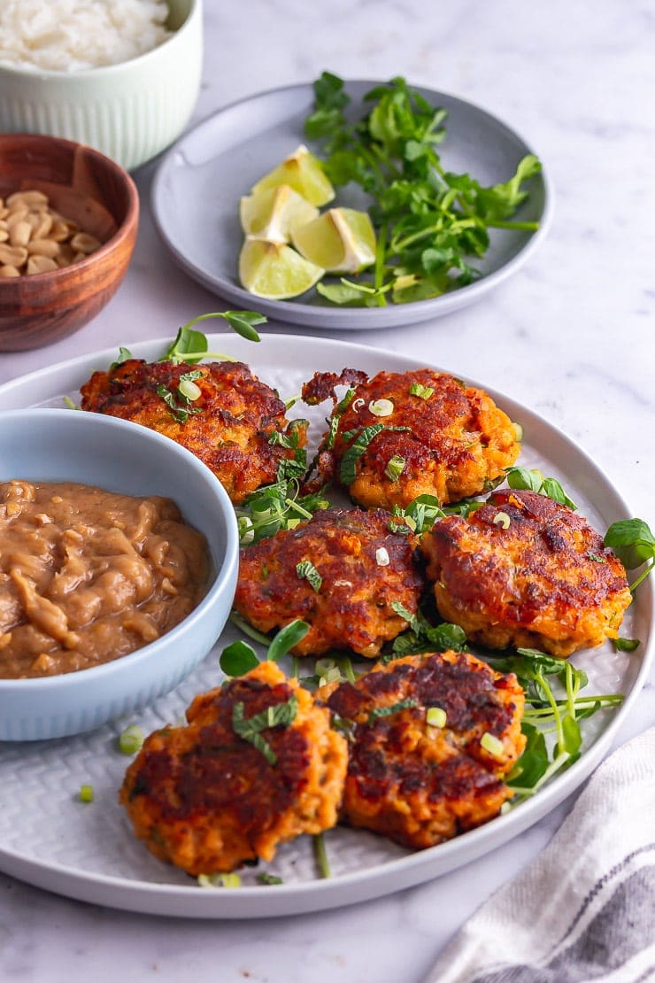 Plate of Thai fish cakes with greens on a marble background