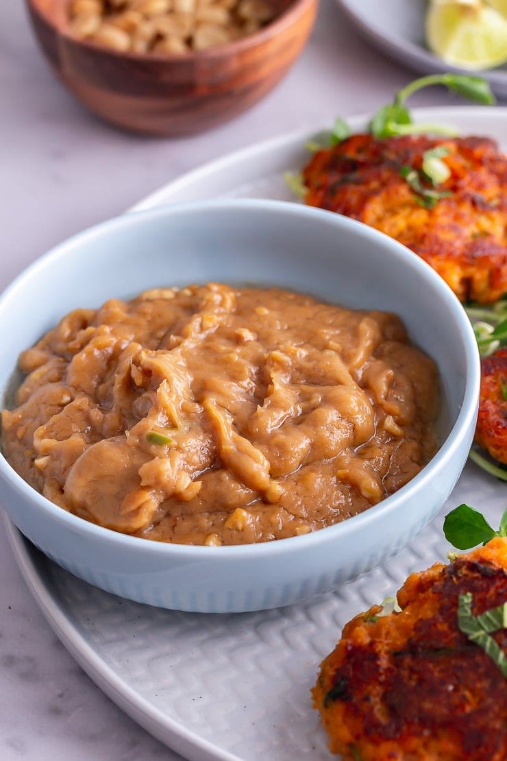 Peanut sauce to go with Thai fish cakes in a blue bowl