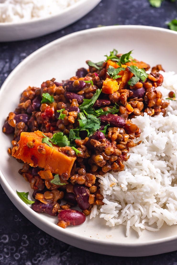 Side on shot of veggie chilli with rice in a white bowl