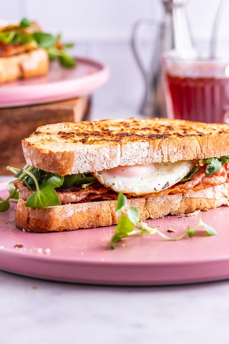 Side on shot of breakfast sandwich on a pink plate