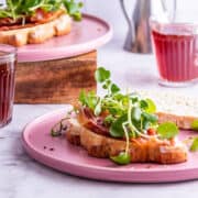 Side on shot of breakfast sandwich on a pink plate