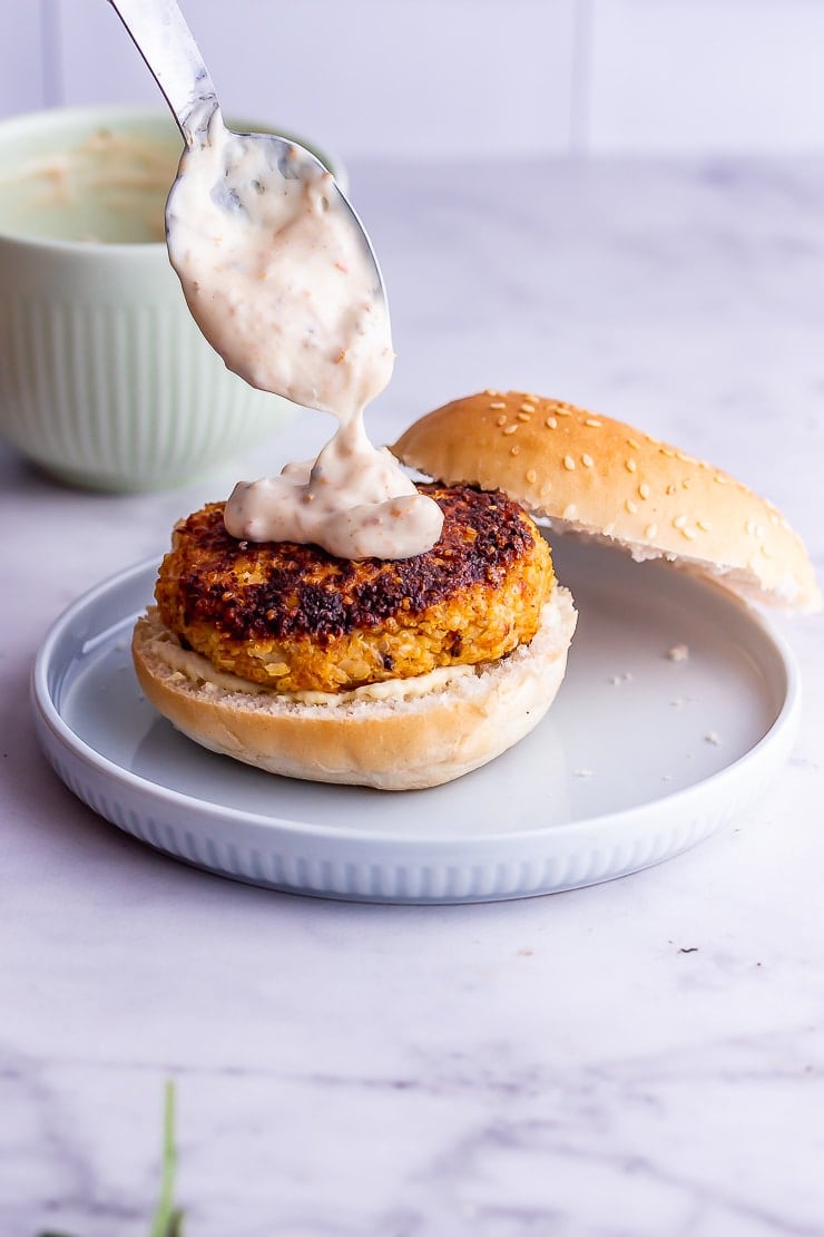 Spoonful of sun dried tomato mayo over veggie burgers