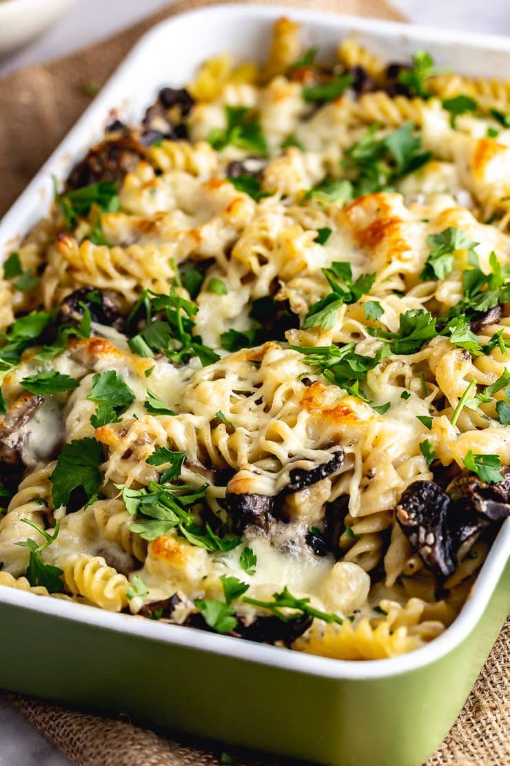 Green baking dish of creamy mushroom pasta bake