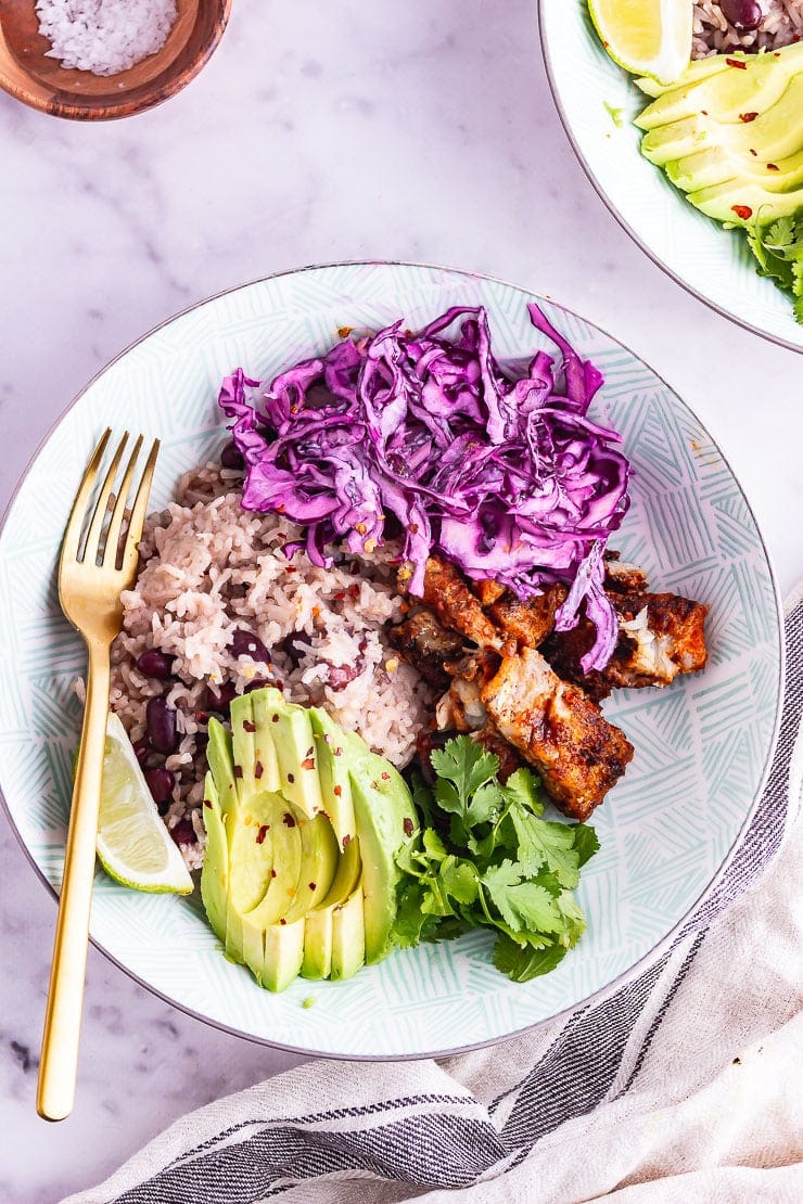 Overhead shot of fish taco bowl in a blue bowl on a marble background