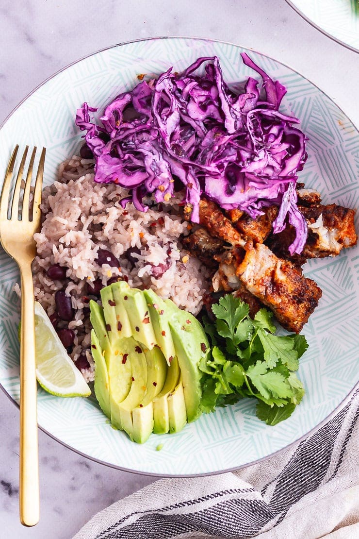 Overhead shot of a fish taco bowl with a gold fork