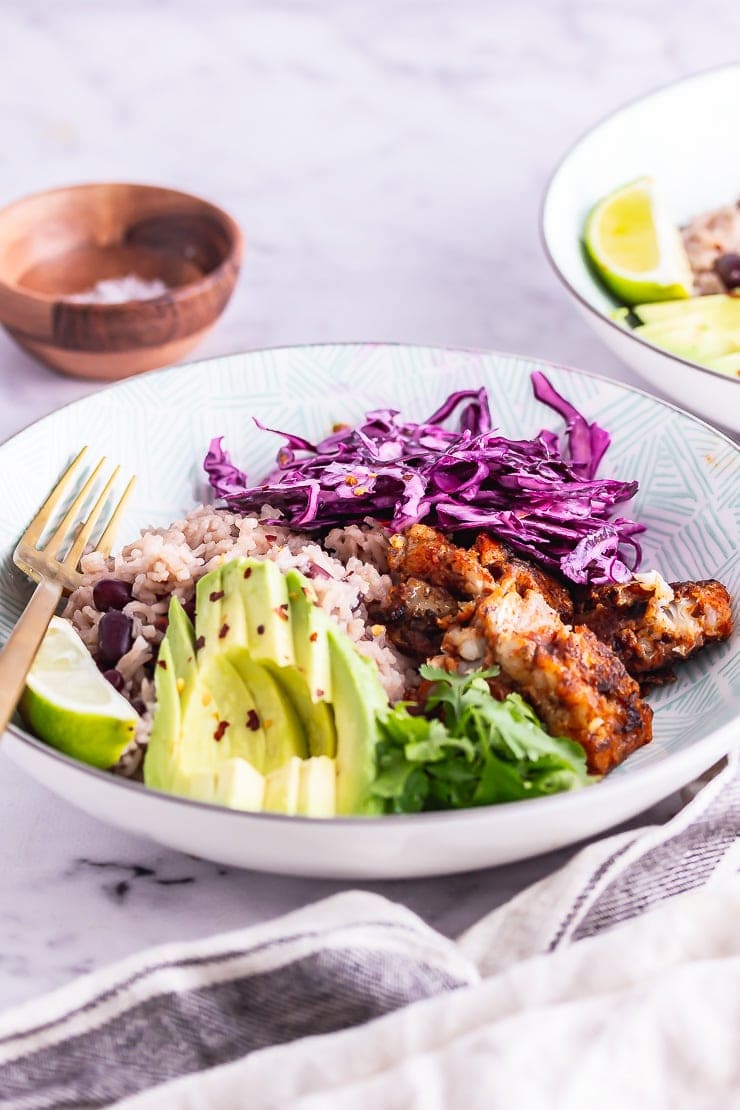 Side on shot of fish taco bowl with a gold fork