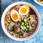 Overhead shot of pork ramen on a blue background