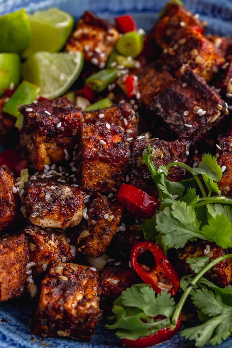 Close up of salt and pepper tofu with lime, chilli and coriander