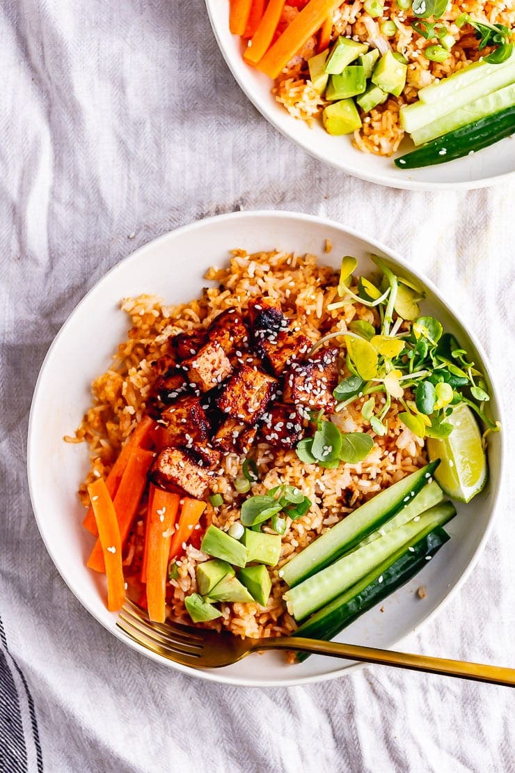 Overhead shot of spicy rice bowls with a gold fork