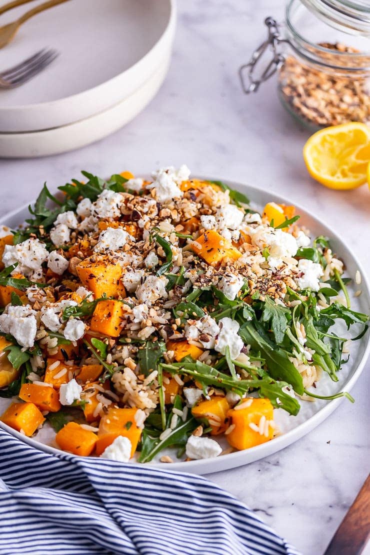 Platter of butternut squash salad on a marble background