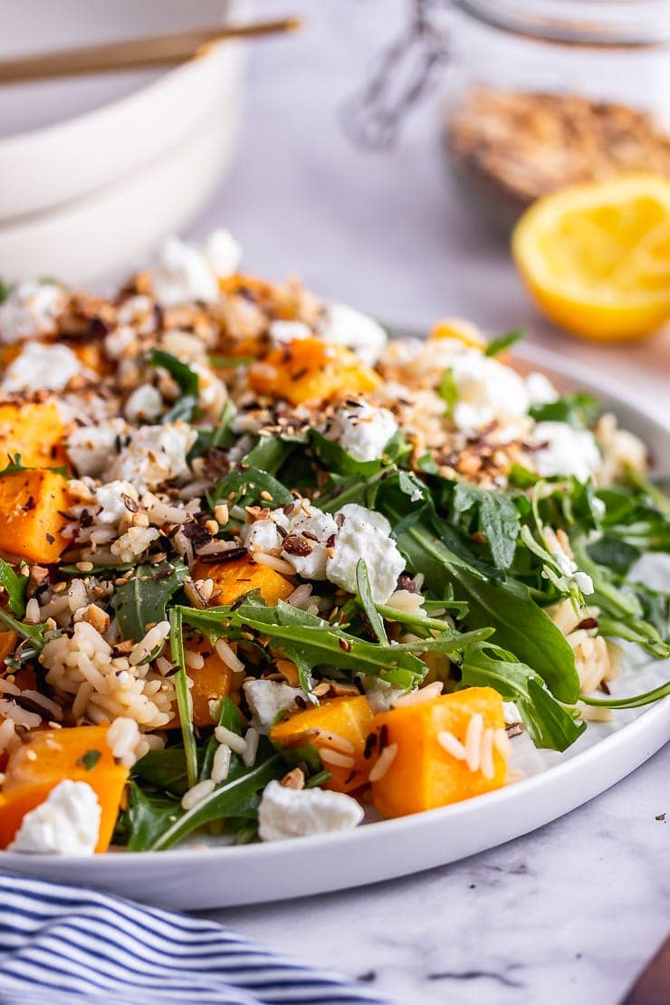 Close up of butternut squash salad on a marble surface