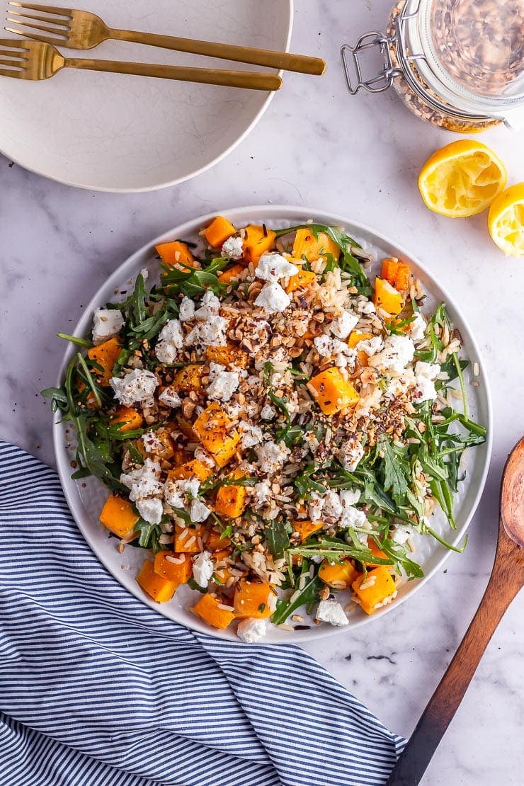 Overhead shot of butternut squash salad on a marble background