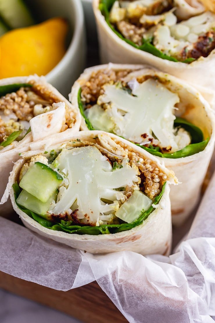 Close up of a veggie wrap in a paper lined tray