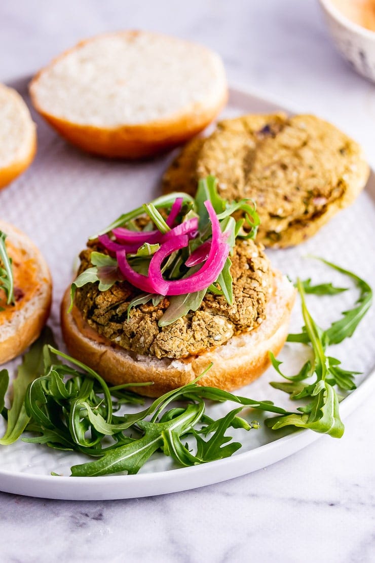 Falafel burger with rocket on a grey plate