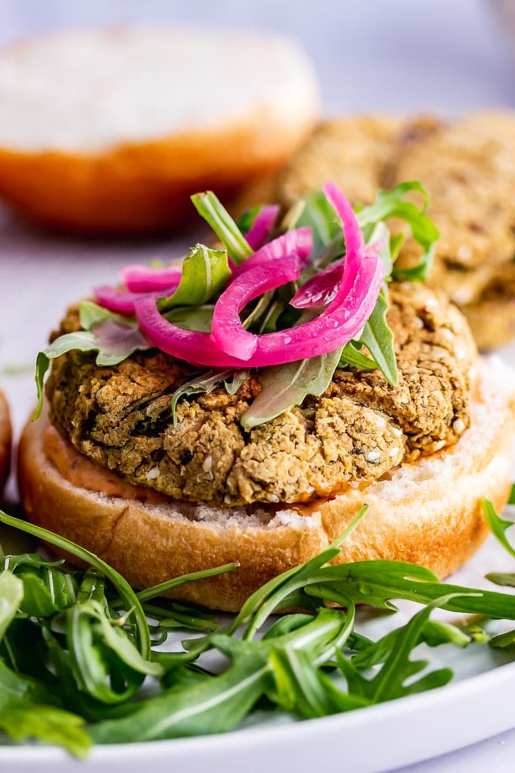 Close up of falafel burger with rocket and pickled onions