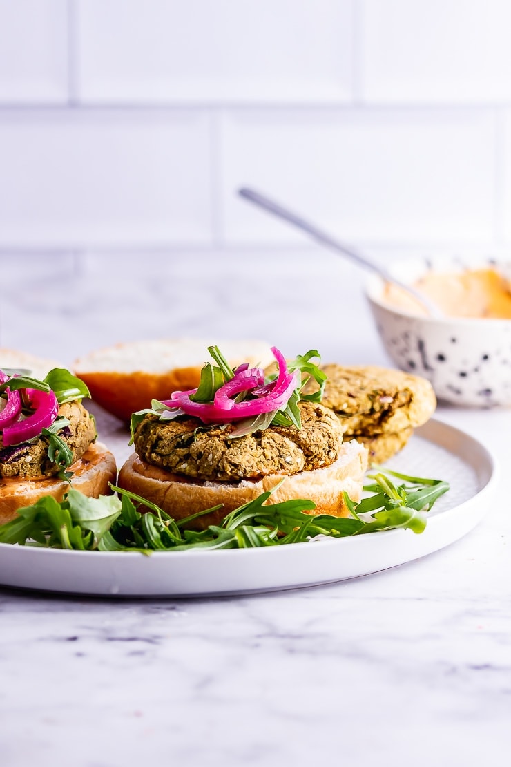 Side on shot of falafel burger on a plate on a marble background