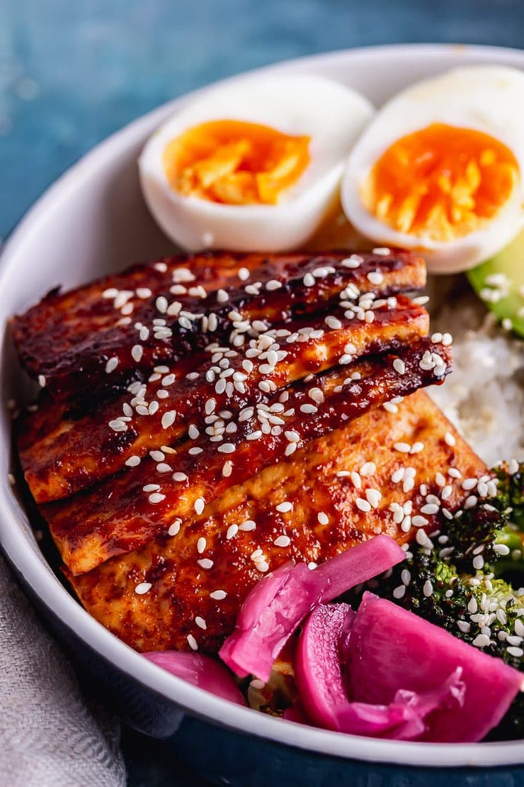 Close up of Korean baked tofu in a rice bowl with a boiled egg