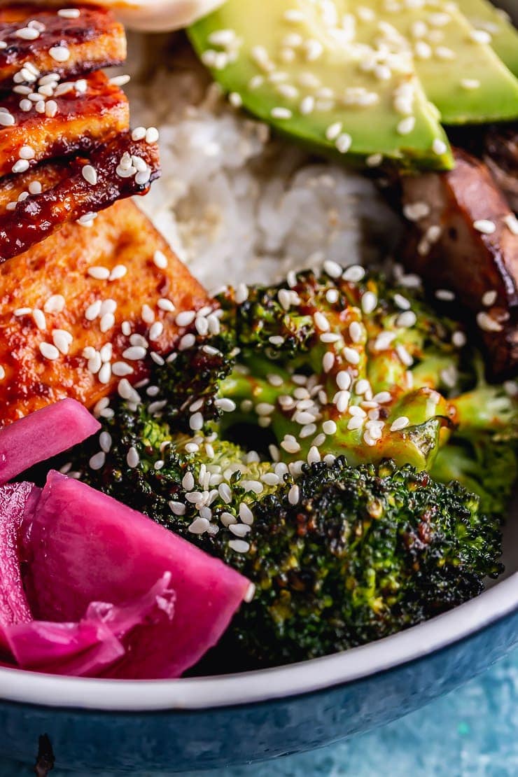 Close up of broccoli in a baked tofu rice bowl