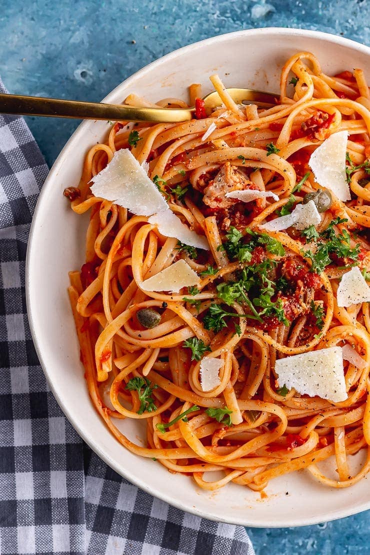 Overhead shot of salmon linguine with parmesan and a gold fork