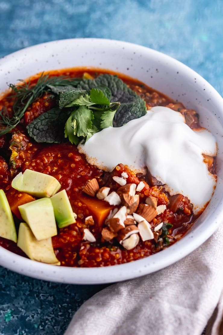 Close up of spicy veggie stew with avocado with a cloth