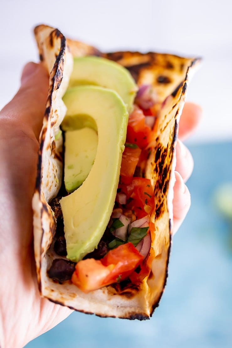Hand holding a vegan breakfast taco