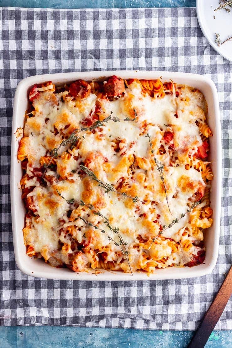 Overhead shot of vegetarian sausage pasta bake on a checked cloth