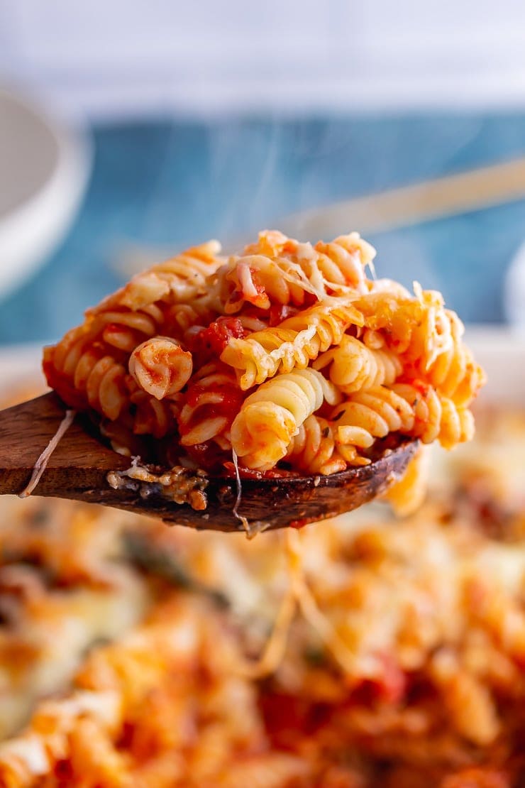 Wooden spoonful of sausage pasta bake