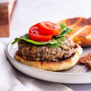 Side on shot of a mushroom burger on a grey plate on a marble background
