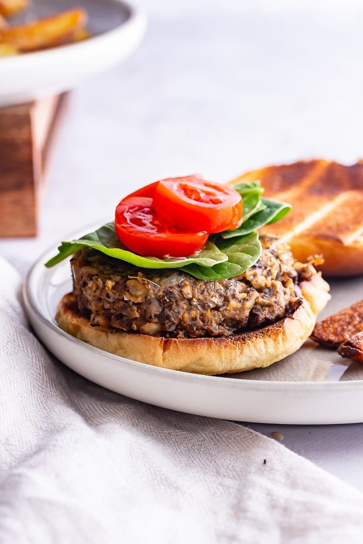 Side on shot of a mushroom burger on a grey plate on a marble background