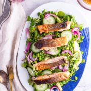 Salmon salad on a platter oven a marble background with a beige cloth