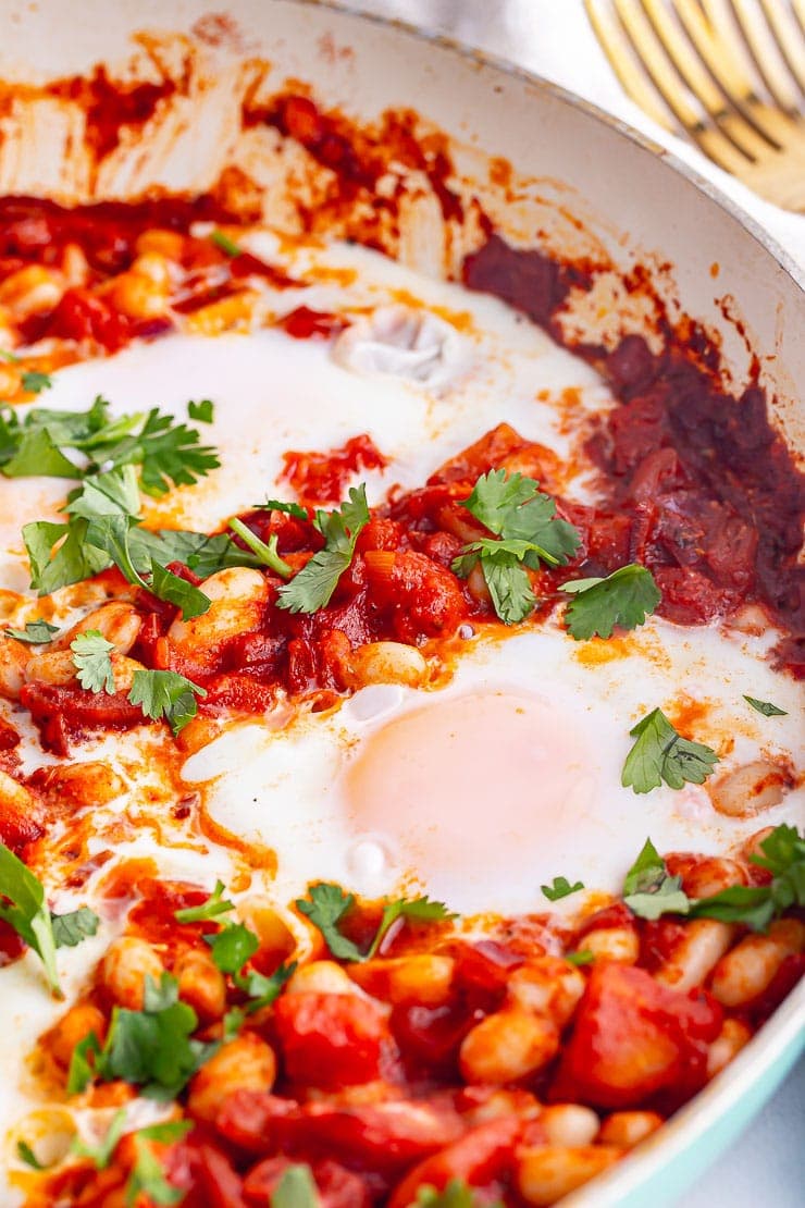Close up of eggs and spicy beans in a breakfast skillet