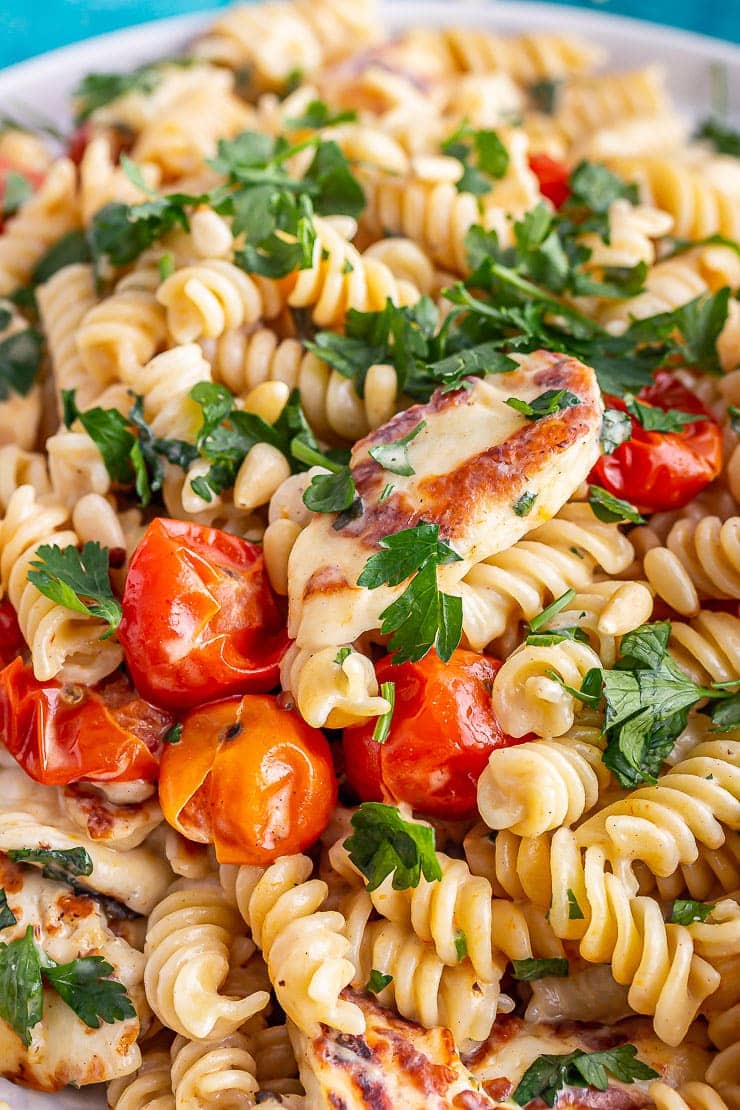 Close up of halloumi pasta with tomato and parsley