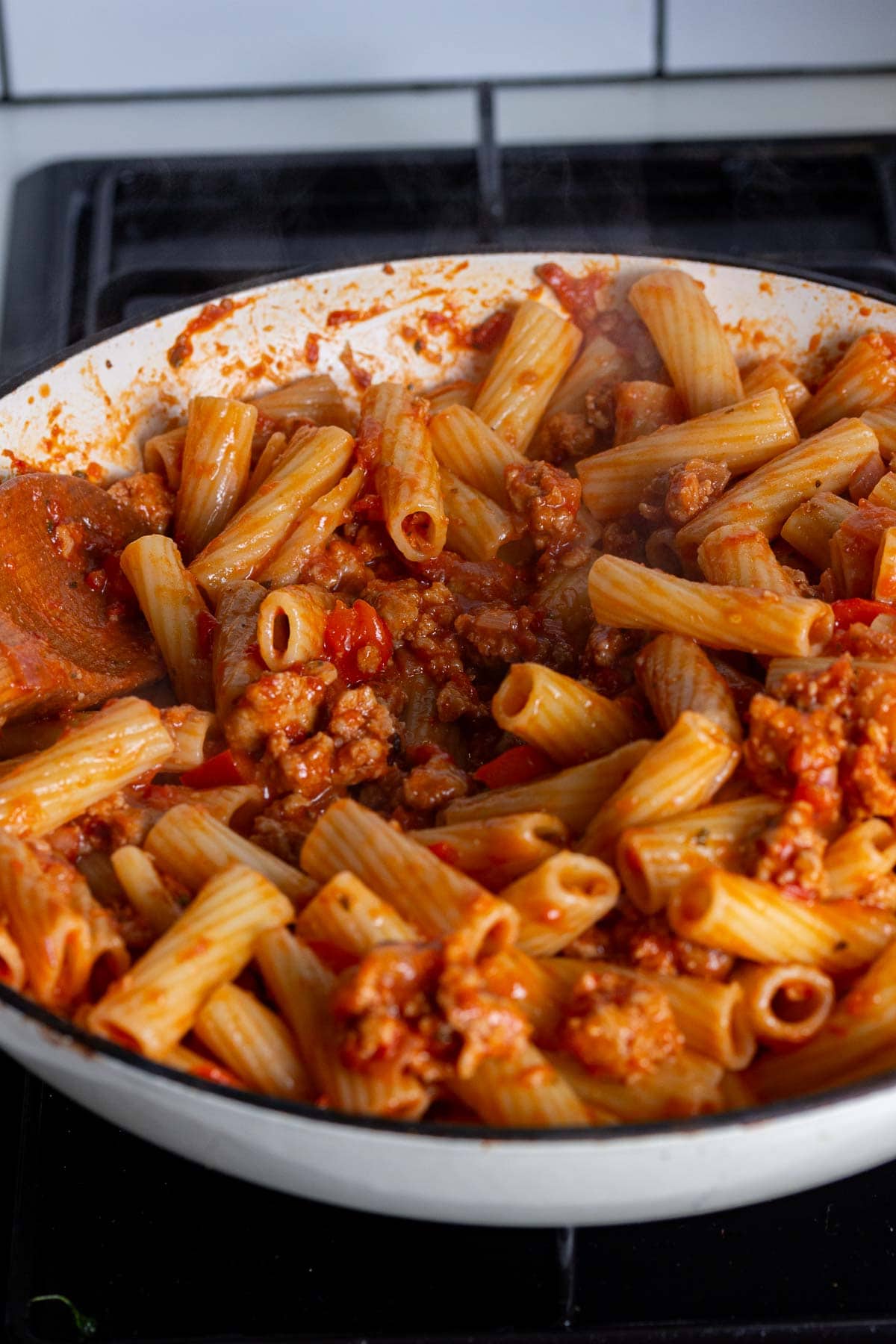 Pasta and sauce cooking in a pan