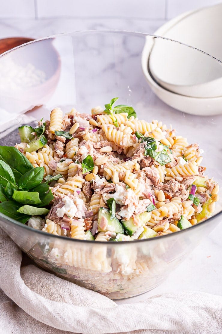 Glass bowl of tuna pasta salad in a marble surface