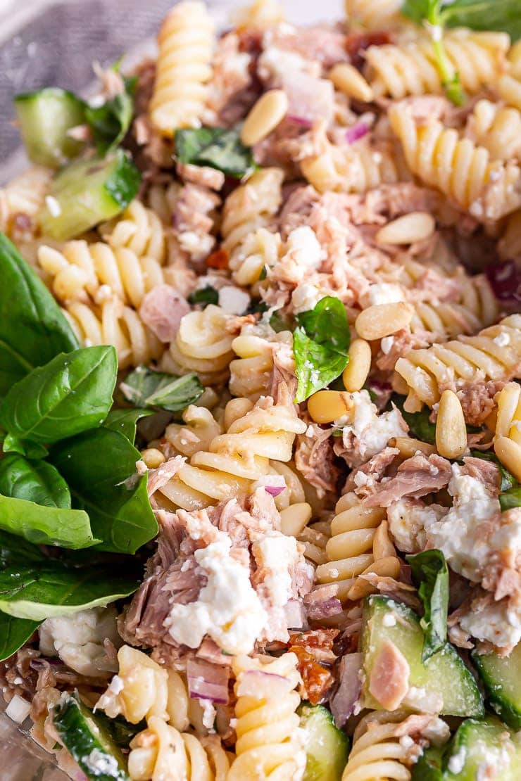 Close up of tuna pasta salad with basil and feta