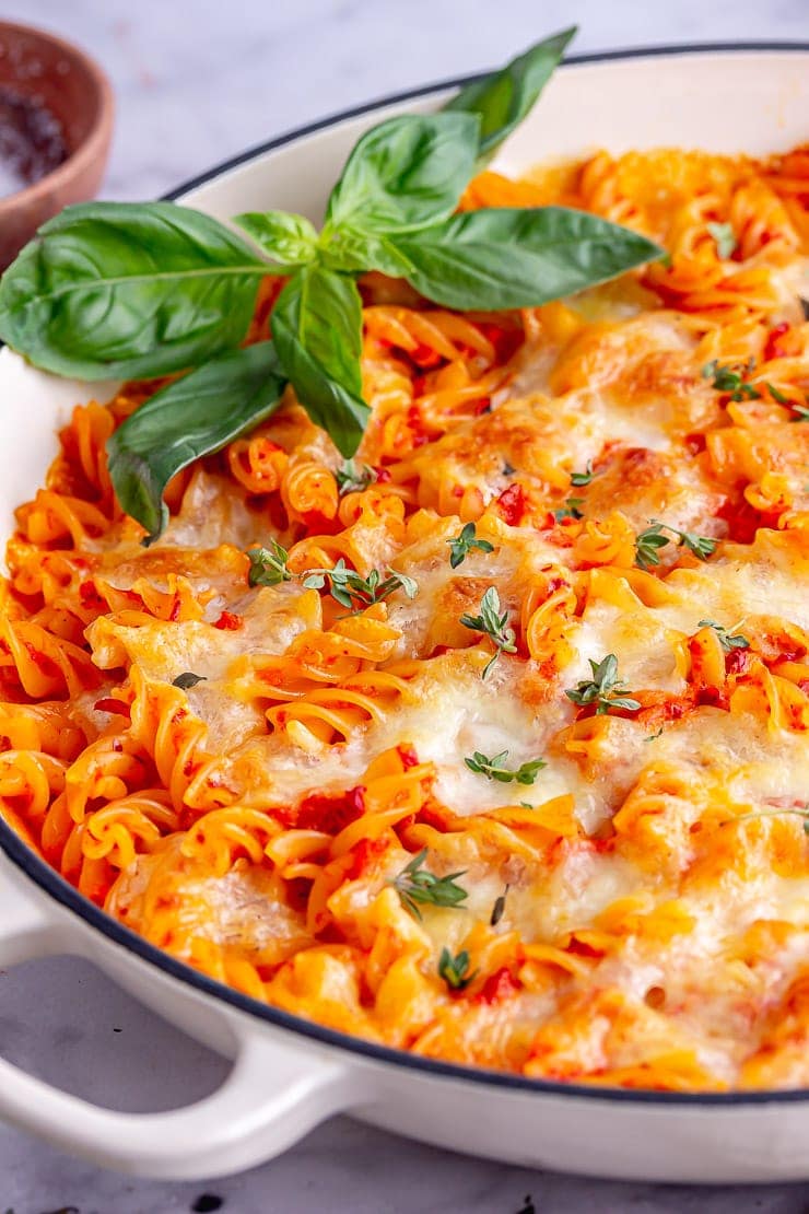 Close up of cheese pasta bake topped with herbs