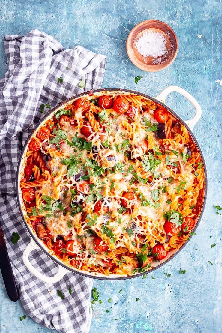 Overhead shot of cheesy pasta with a checked cloth