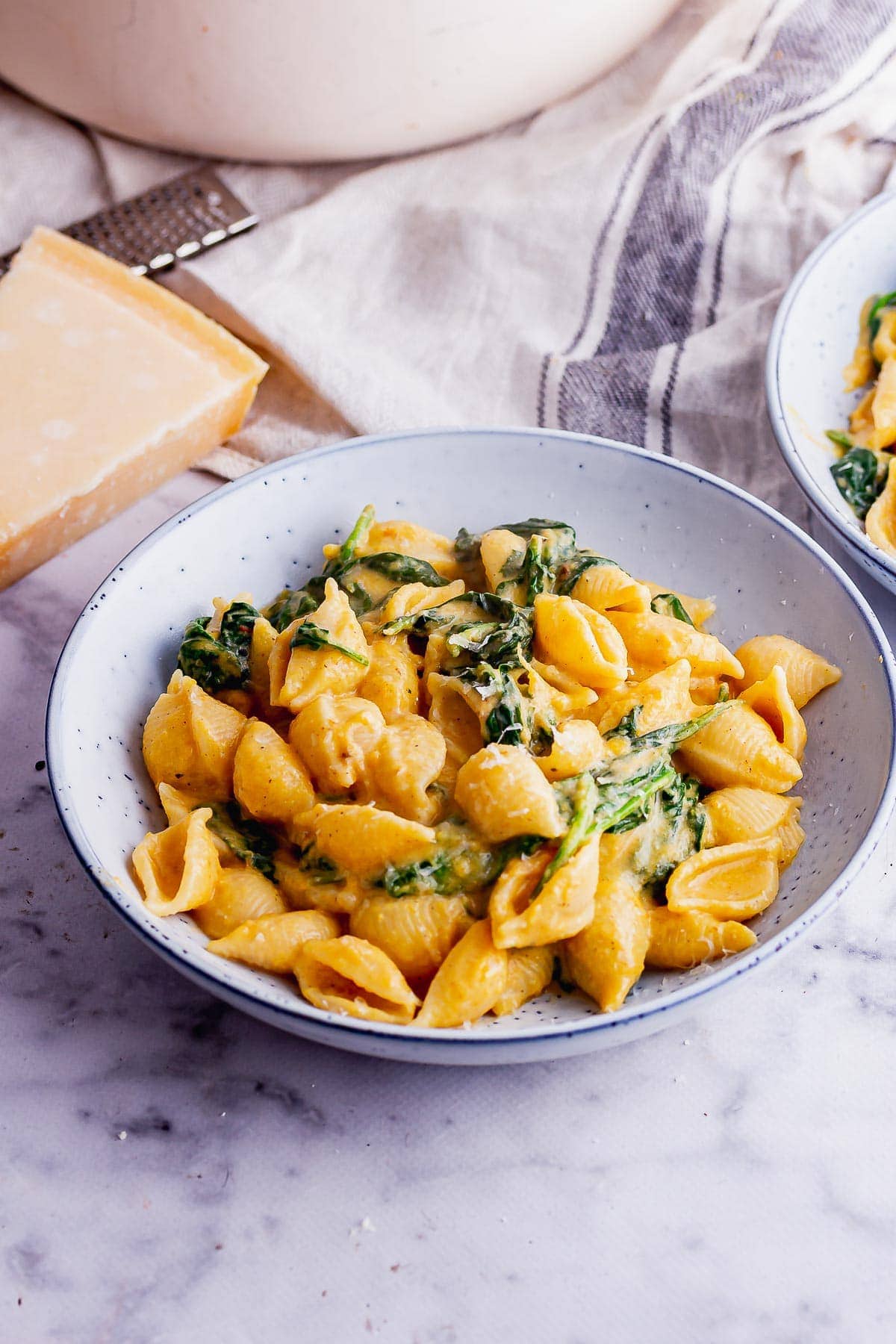 Blue bowl of squash pasta sauce on a marble background