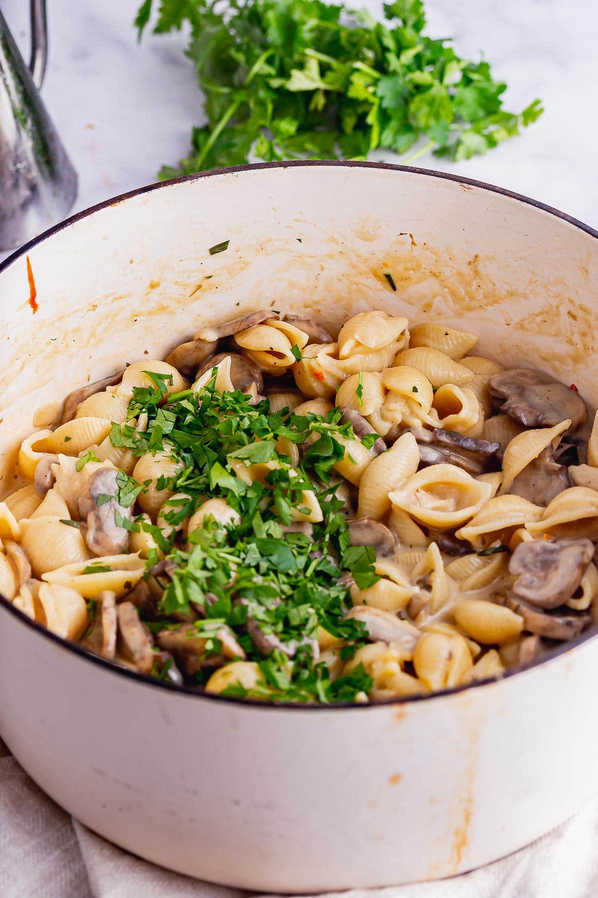 White pot of vegetarian stroganoff on a marble background