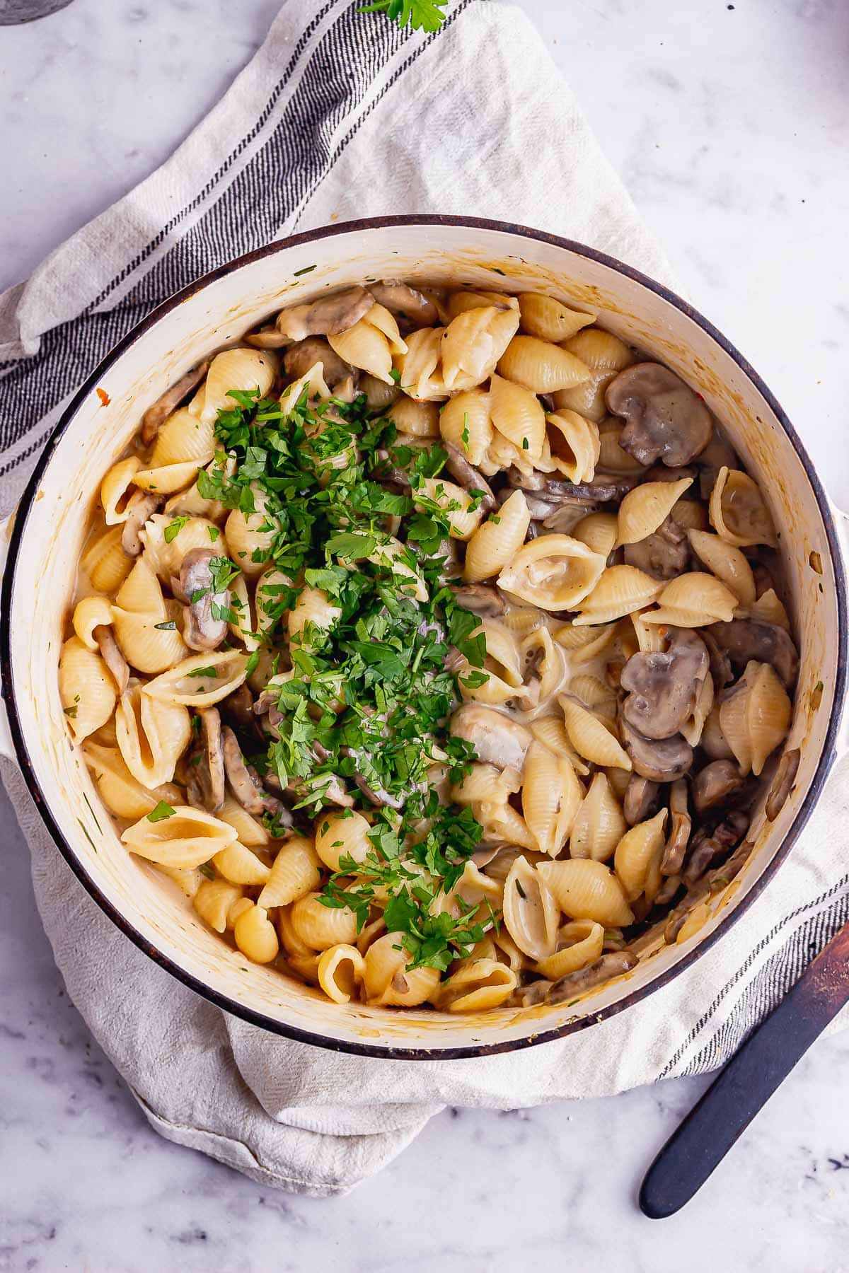 Overhead shot of vegetarian stroganoff with pasta in a white pot