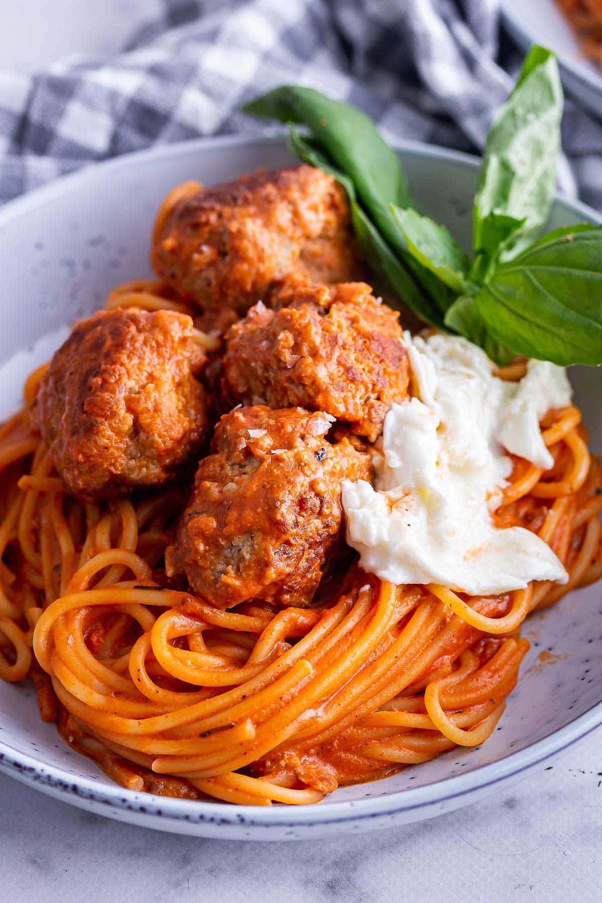 Close up of turkey meatballs with mozzarella and spaghetti