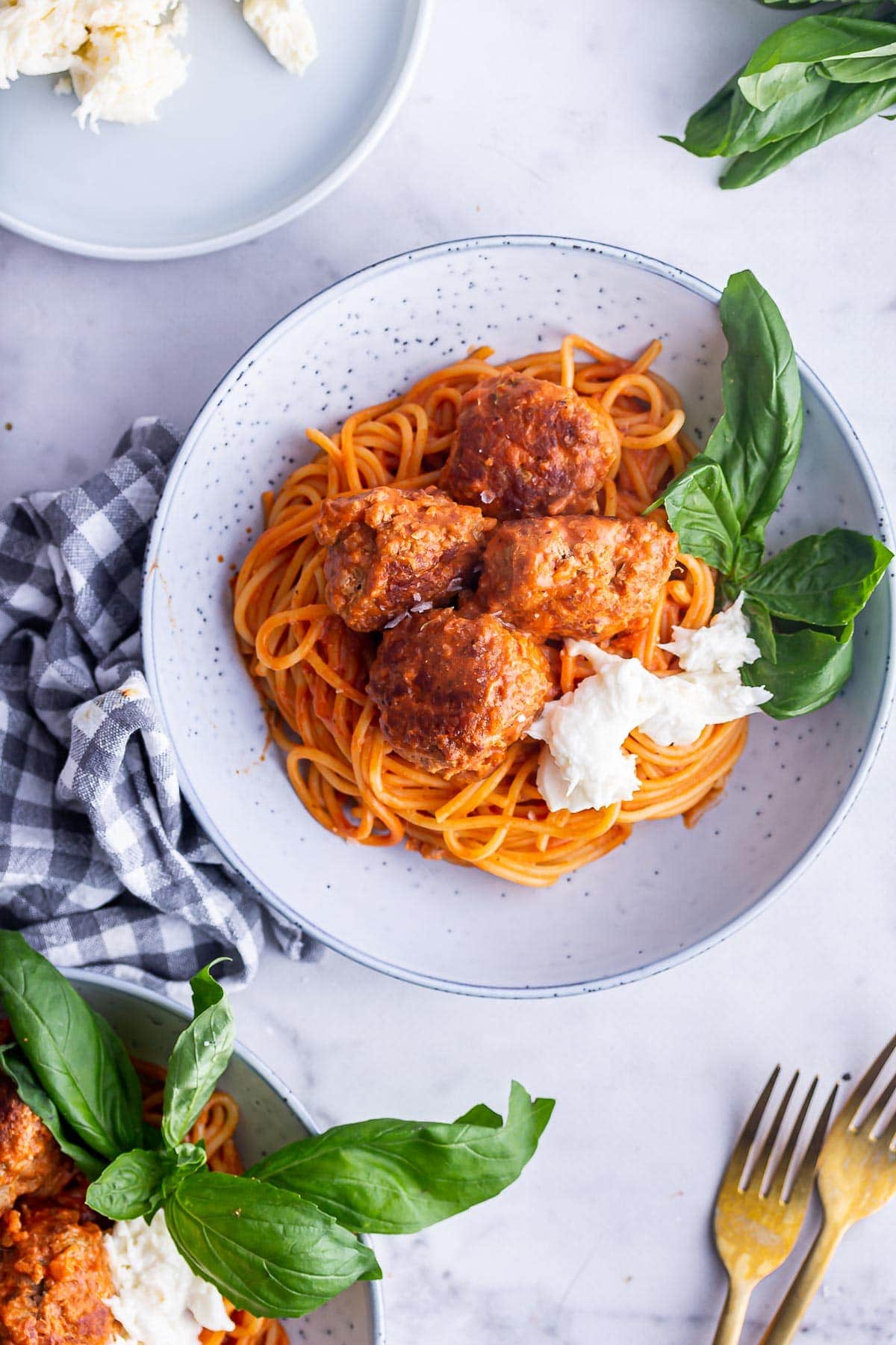 Overhead shot of turkey meatballs in a grey bowl on a marble background