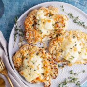 Cheesy cauliflower steak with cloth and gold fork