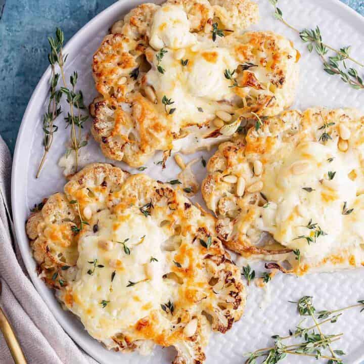 Cheesy cauliflower steak with cloth and gold fork