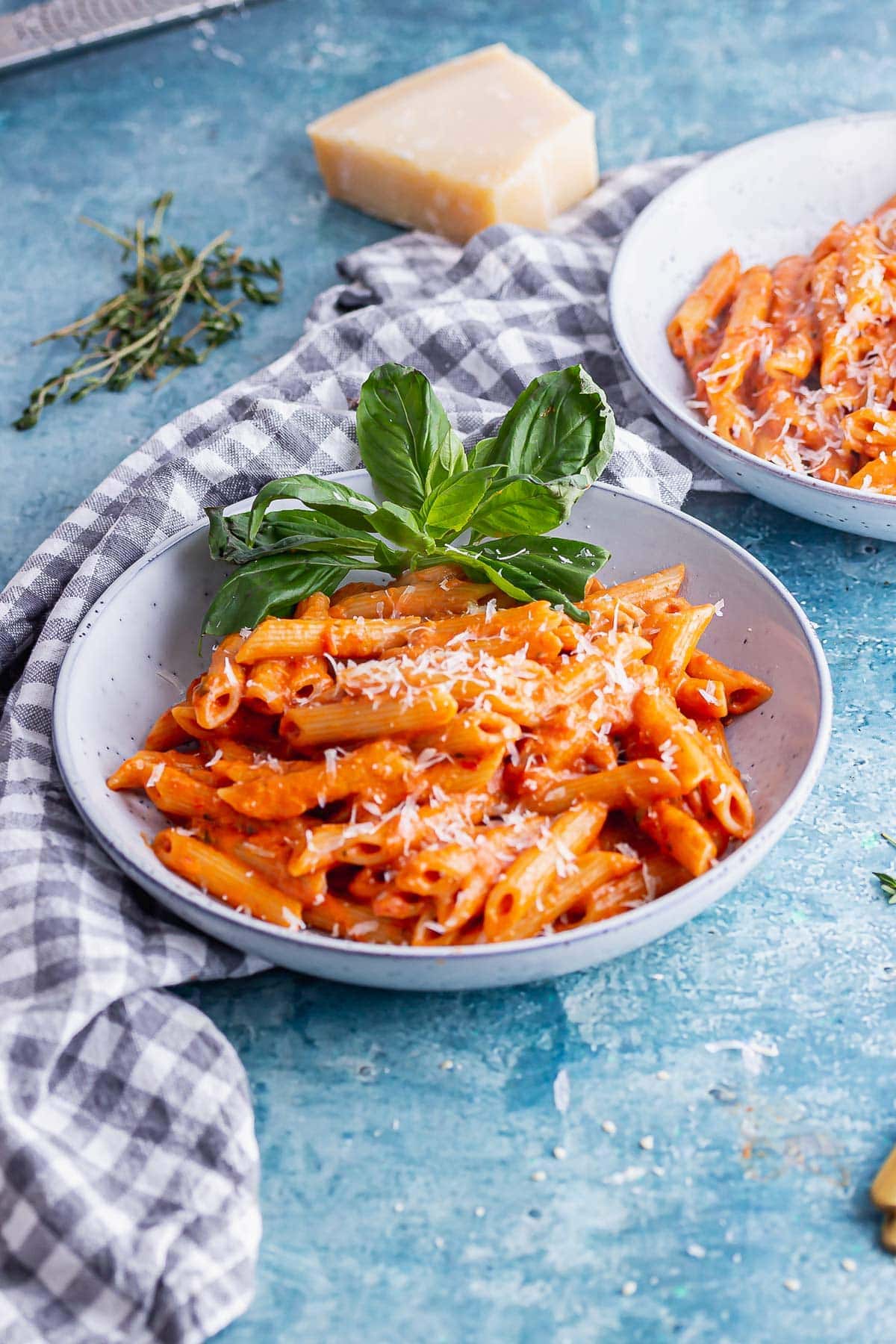 Blue bowl of vodka pasta on a blue background