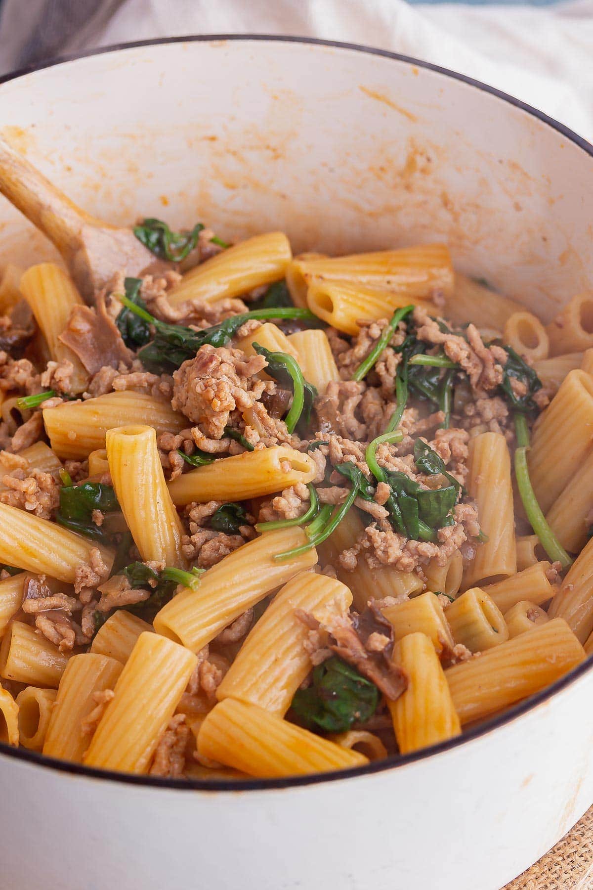 White pot of pork mince pasta with spinach