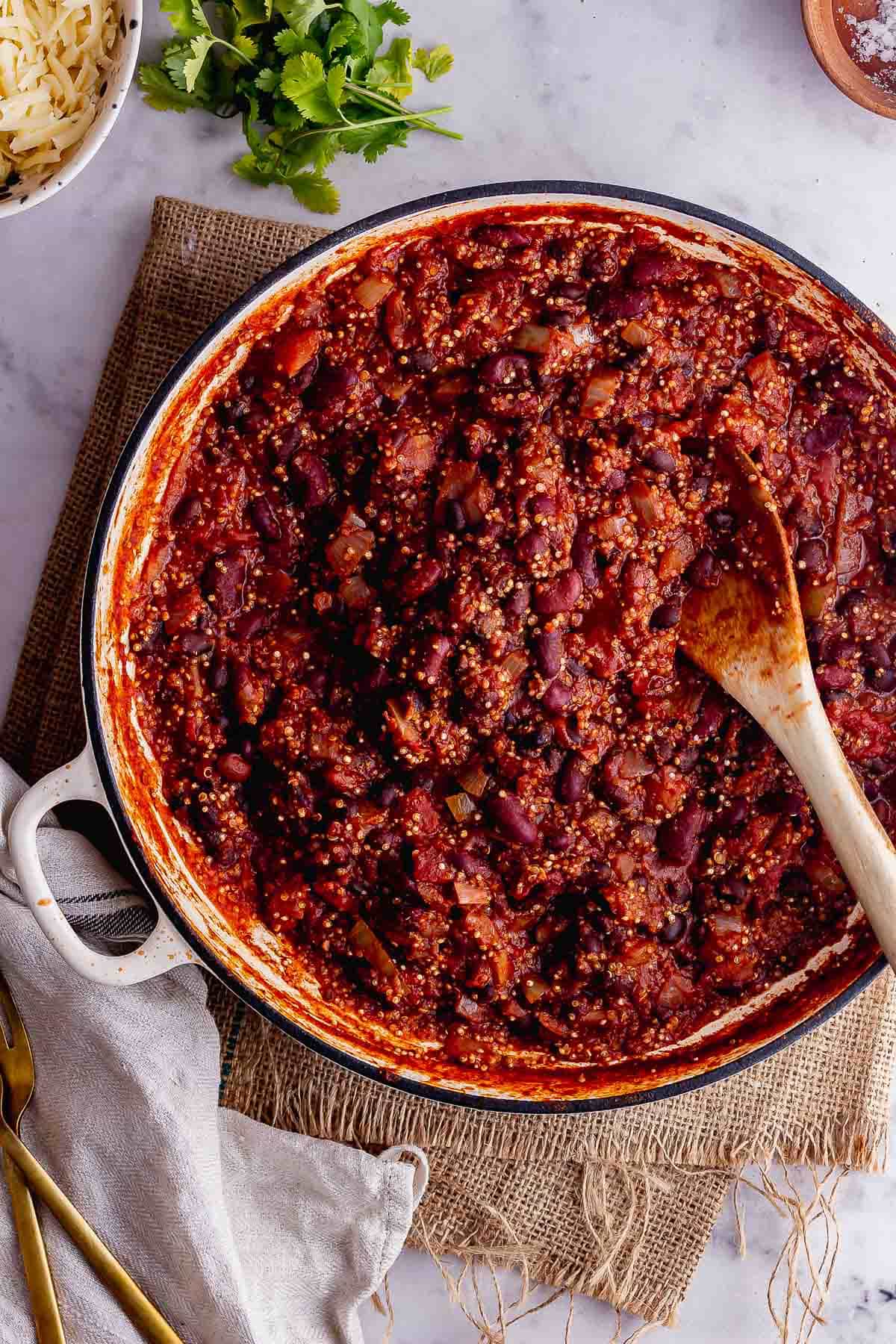 Overhead shot of veggie chilli with quinoa on a marble background