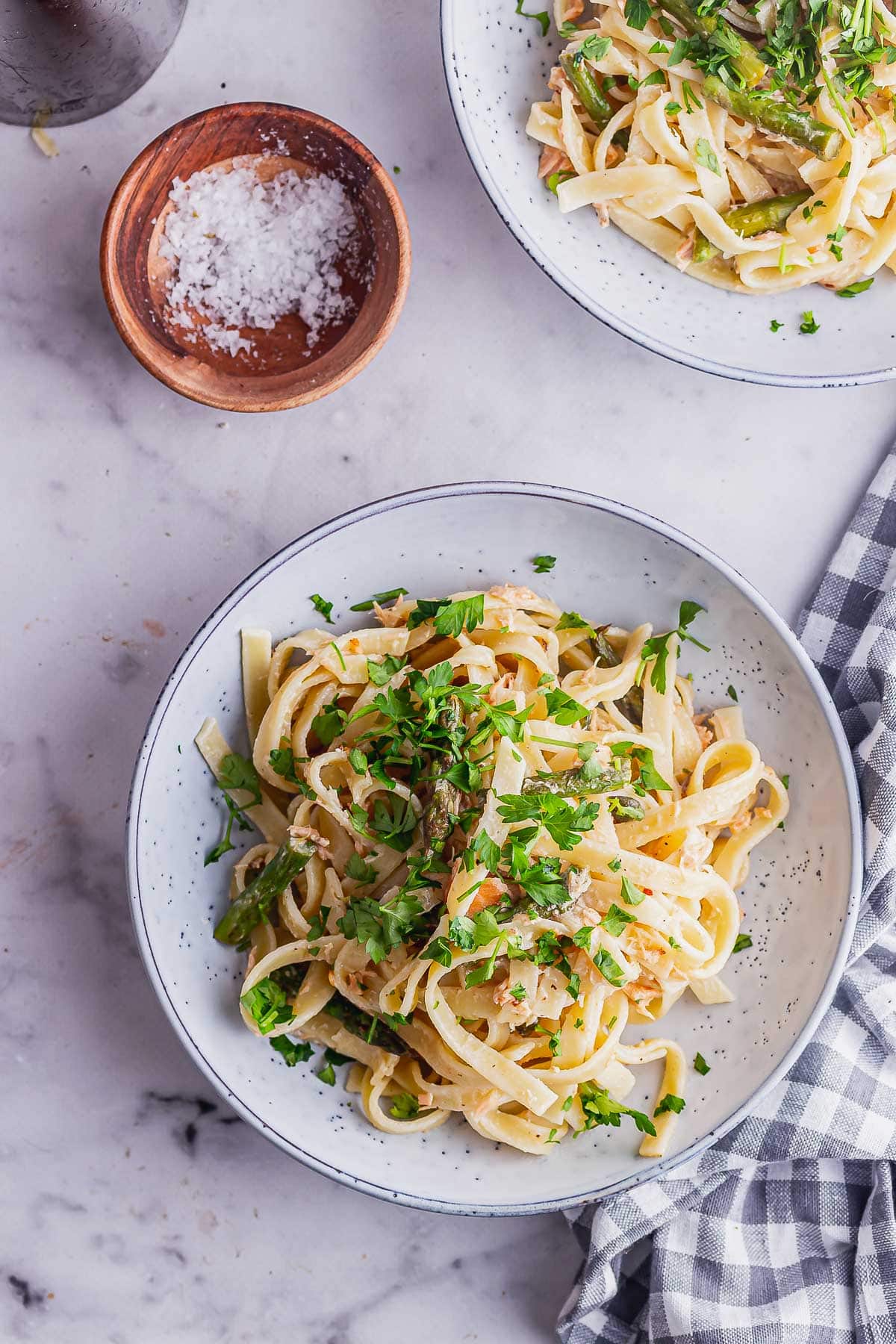 Overhead shot of smoked salmon tagliatelle on a marble background